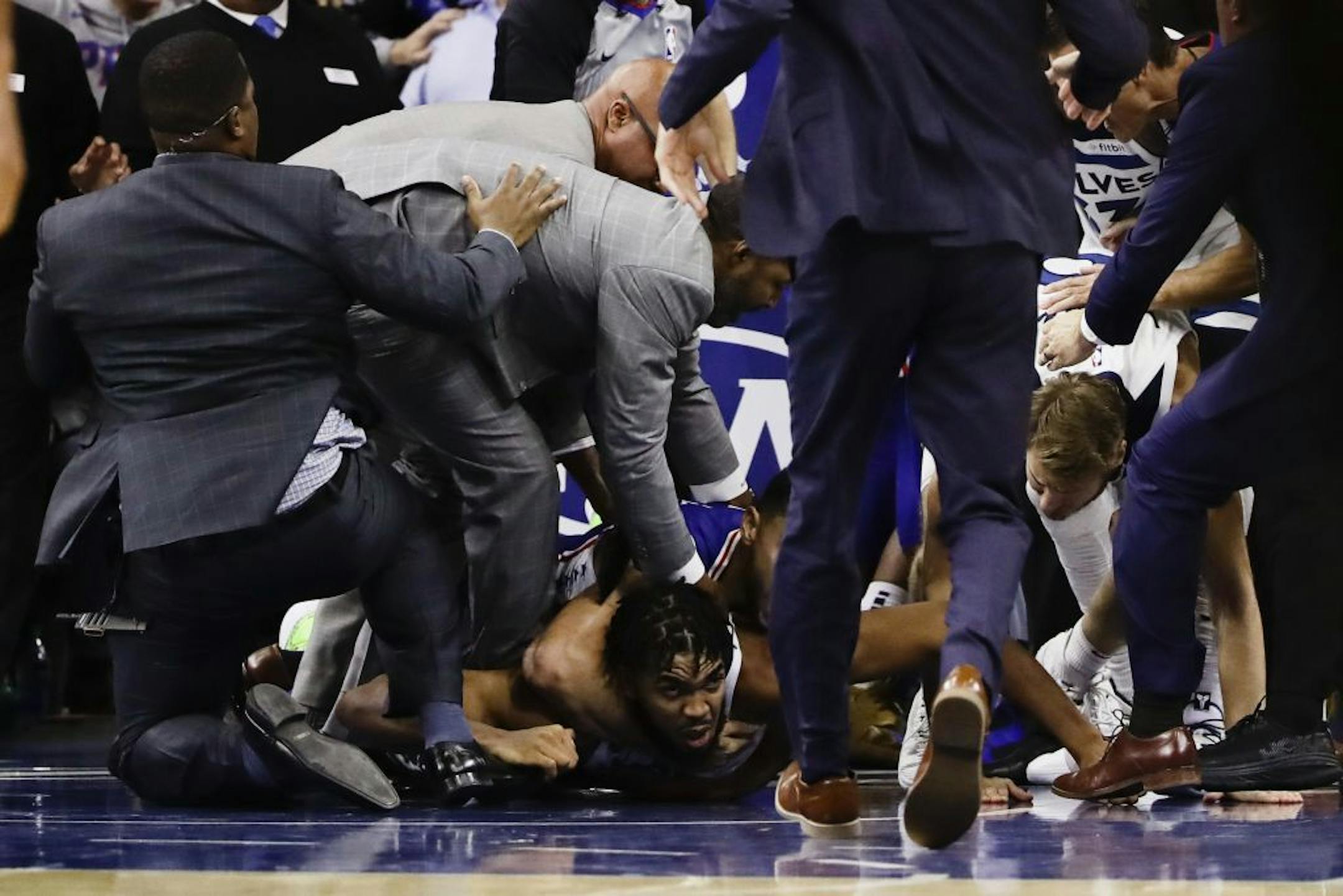Minnesota Timberwolves' Karl-Anthony Towns lies on the court after an altercation with Philadelphia 76ers' Joel Embiid during the second half of an NBA basketball game Wednesday, Oct. 30, 2019, in Philadelphia. Both players were ejected. The 76ers won 117-95.