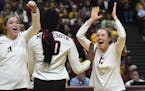 Gophers players including, from left, middle blocker Regan Pittman (21), outside hitter Adanna Rollins (20) and setter Samantha Seliger-Swenson (13) c