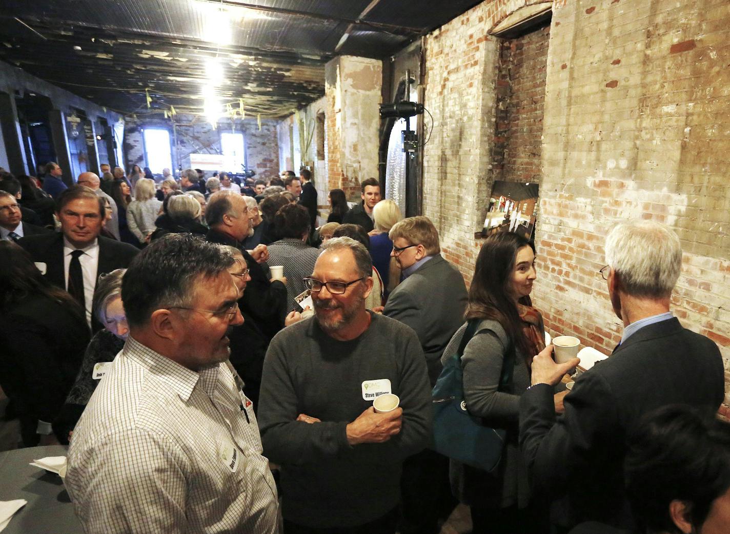 Visitors mingle during the Conley-Maass building open house Thursday, Feb. 18, 2016, in downtown Rochester.