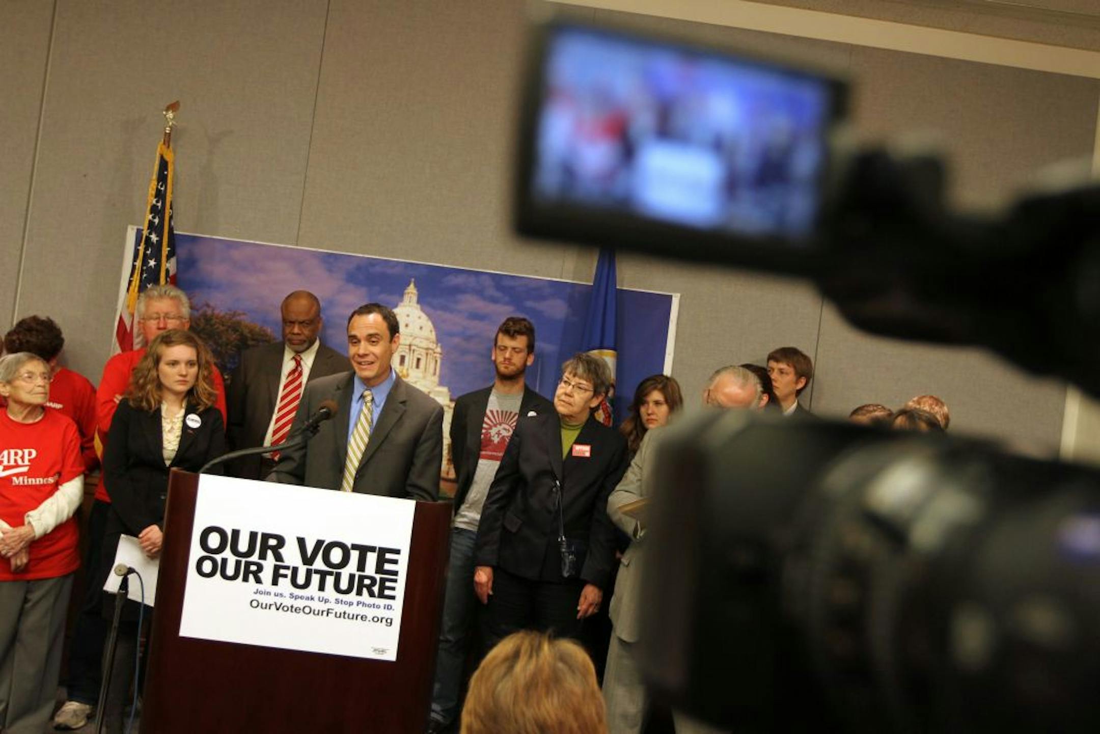 TakeAction Minnesota's Dan McGrath, at lectern, announced the "Our Vote Our Future" campaign to oppose a proposed constitutional amendment on voting.