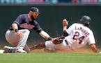 Minnesota Twins' Ryan LaMarre, right, beats the tag by Cleveland Indians second baseman Jason Kipnis to steal second base in the fourth inning of a ba