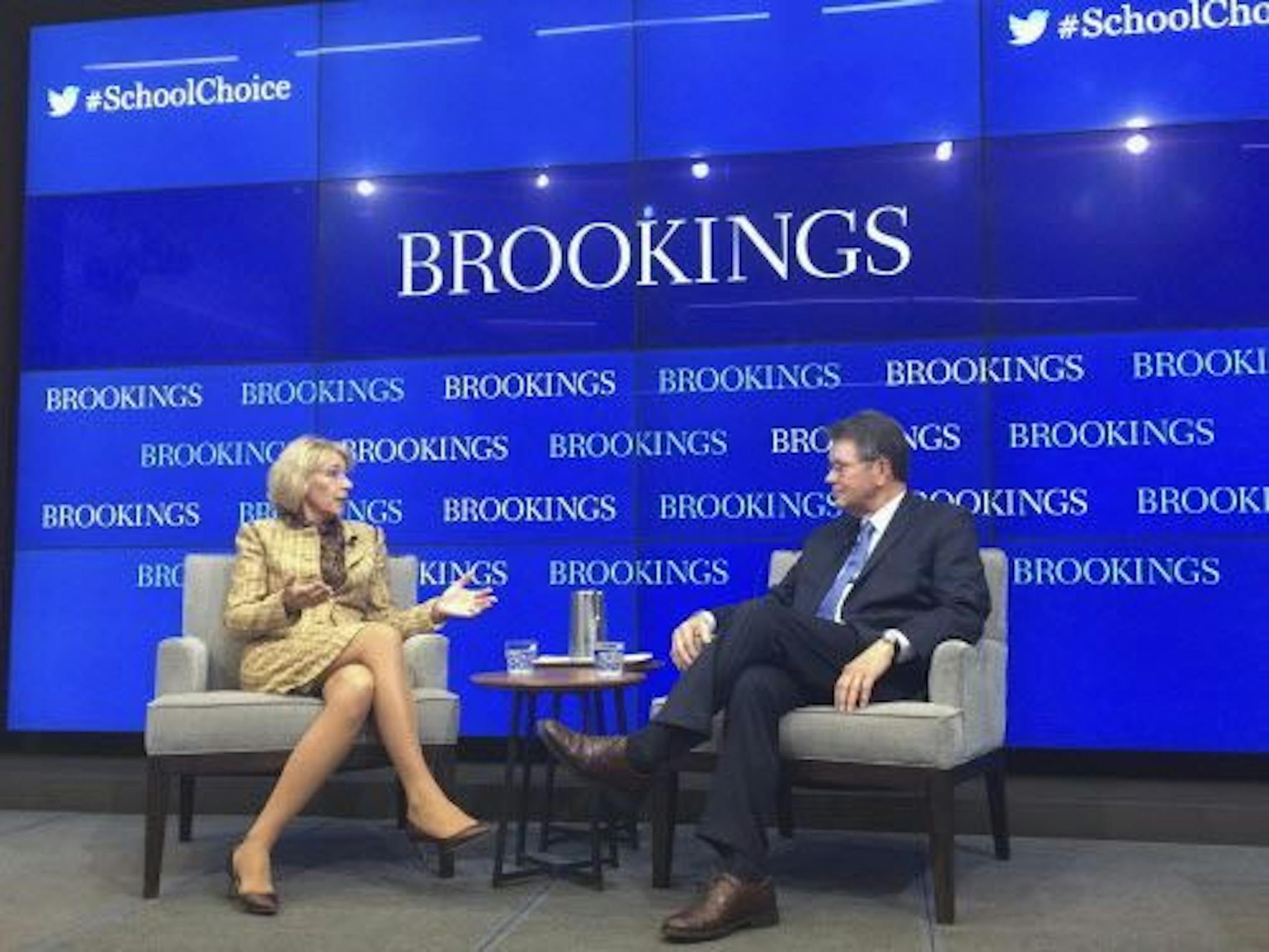 Education Secretary Betsy DeVos talks with Russ Whitehurst, senior fellow in the Center on Children and Families in the Economic Studies program at the Brookings Institution, Wednesday, March 29, 2017, in Washington. DeVos said her predecessor wasted billions of dollars trying to fix traditional public schools.