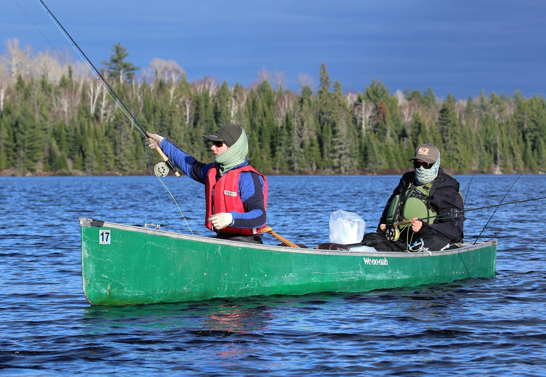 Carson Spohn of Duluth casts a fly in search of lake trout while his paddling partner, Aaron Youngblom looks on. The pair were paddling and fishing in Quetico Provincial Park.