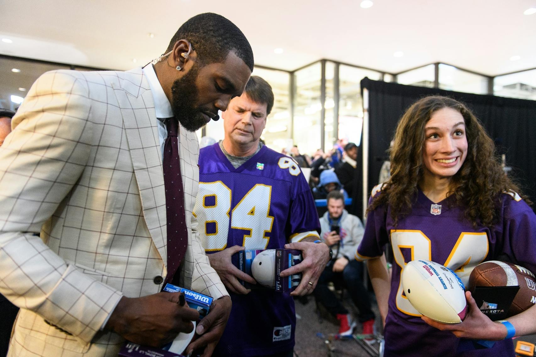 Former NFL wide receiver Randy Moss signed autographs for Eagan girls' track coach Rob Graham and team captain Natalie Windels Thursday after Moss made an appearance on ESPN's SportsCenter at the IDS Center. 