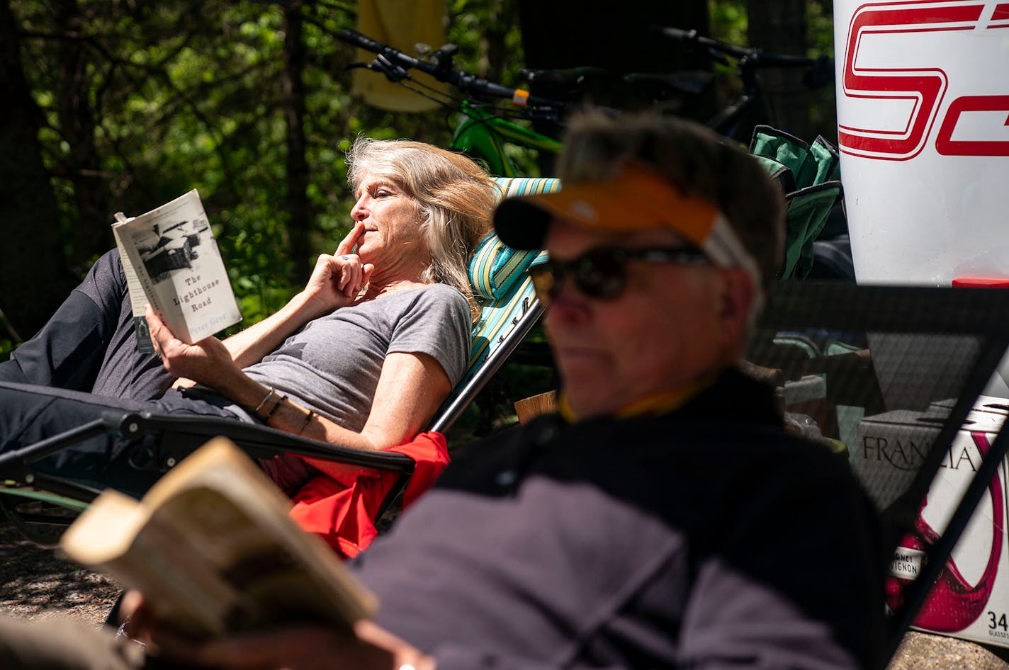 Shelly Mahowald and Brad Swenson read books May 26 at their campsite at Jay Cooke State Park.