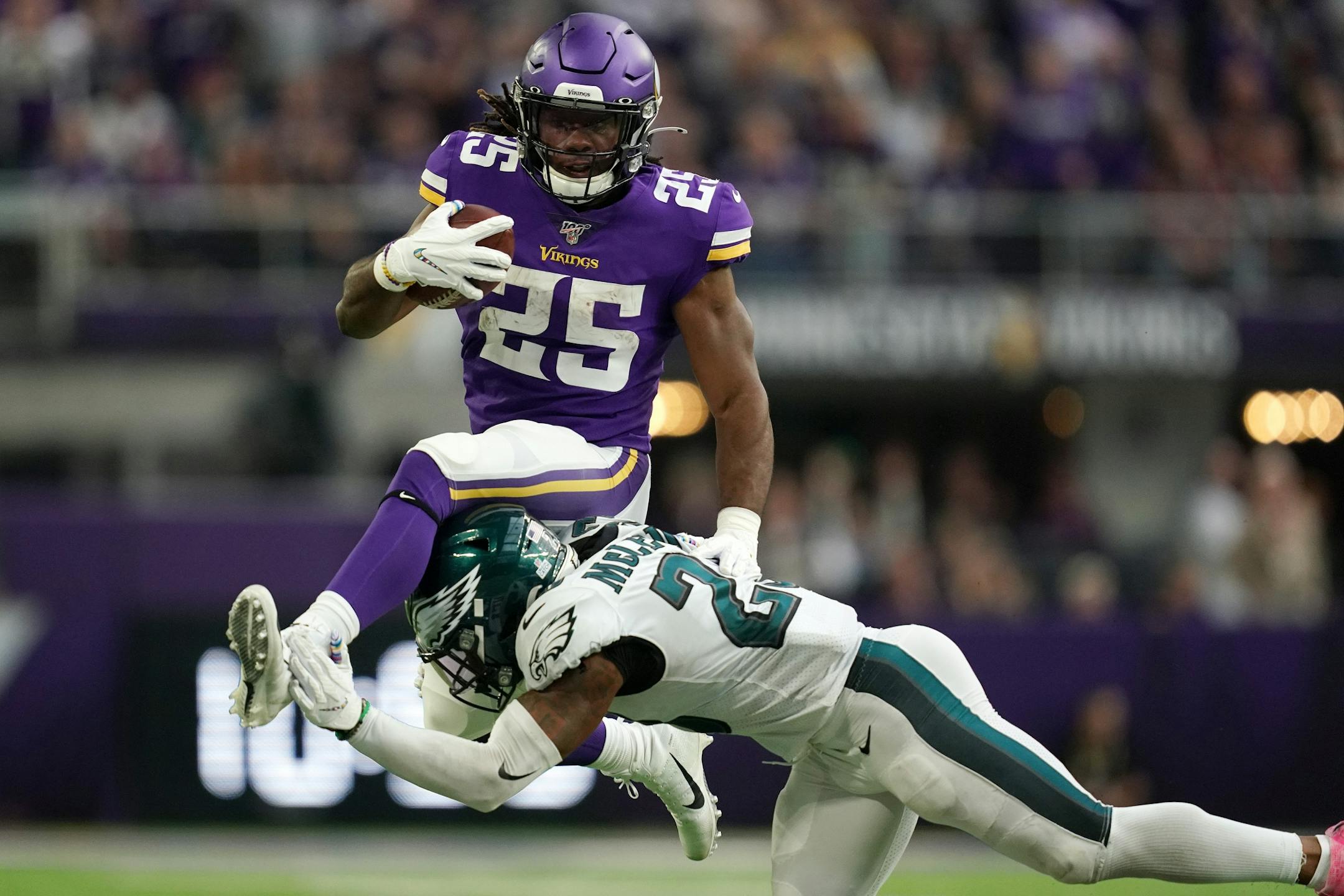 Minnesota Vikings running back Alexander Mattison (25) leapt over the block of Philadelphia Eagles free safety Rodney McLeod (23) as he ran the ball in the fourth quarter.