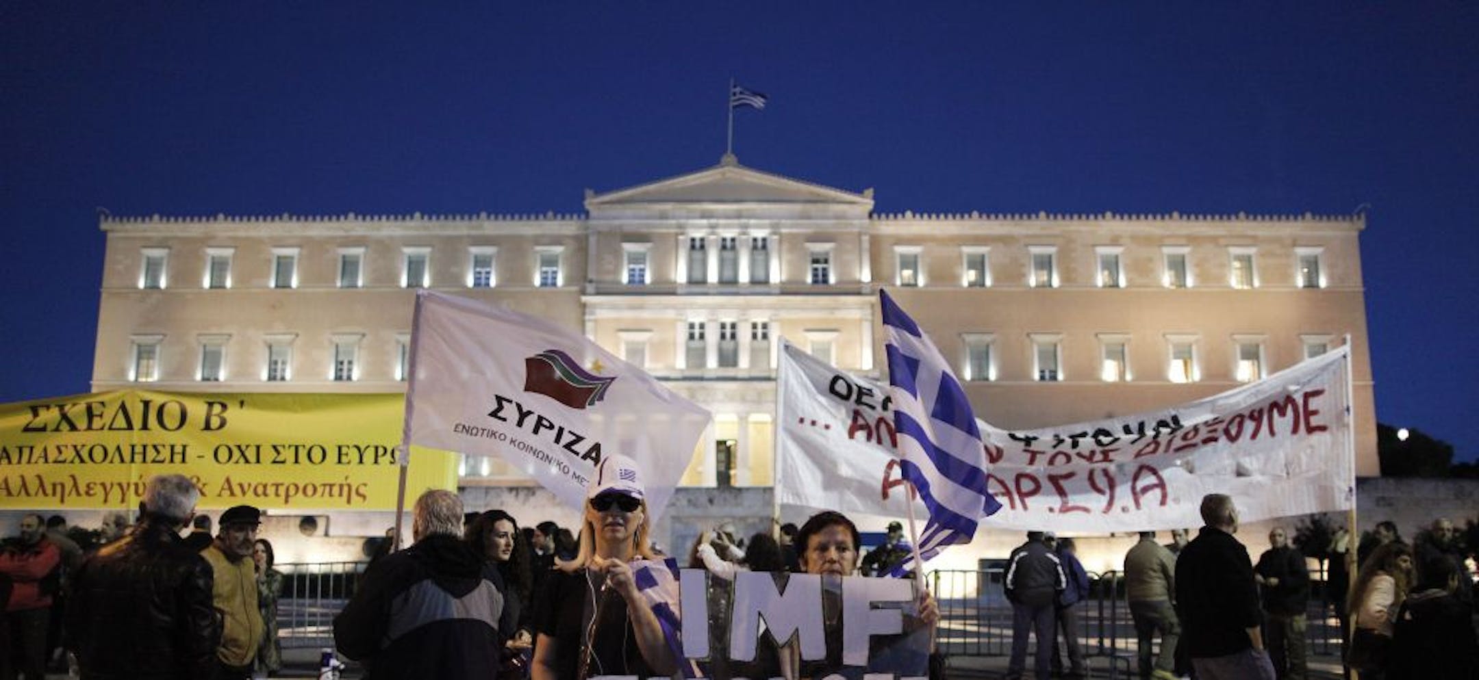 Demonstrators protested austerity measures Sunday outside the Greek Parliament in Athens as lawmakers met to pass a budget that will bring about $9 billion in cuts to benefits and salaries.