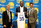 Golden State Warriors' newest player Kevin Durant, center, joins head coach Steve Kerr, left and general manager Bob Myers during a news conference at