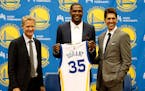 Golden State Warriors' newest player Kevin Durant, center, joins head coach Steve Kerr, left and general manager Bob Myers during a news conference at