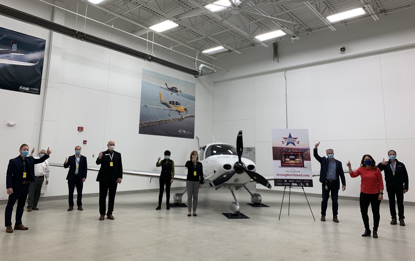 Leaders from Cirrus Aircraft pose alongside Duluth restaurant owners and business group representatives at a press conference for the new Strong Northland initiative, a voucher program aimed at supporting dining establishments hit hard by the COVID-19 pandemic.