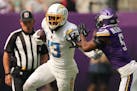 Los Angeles Chargers wide receiver Keenan Allen (13) pushes off the tackle by Minnesota Vikings cornerback Mekhi Blackmon (5) in the second quarter of