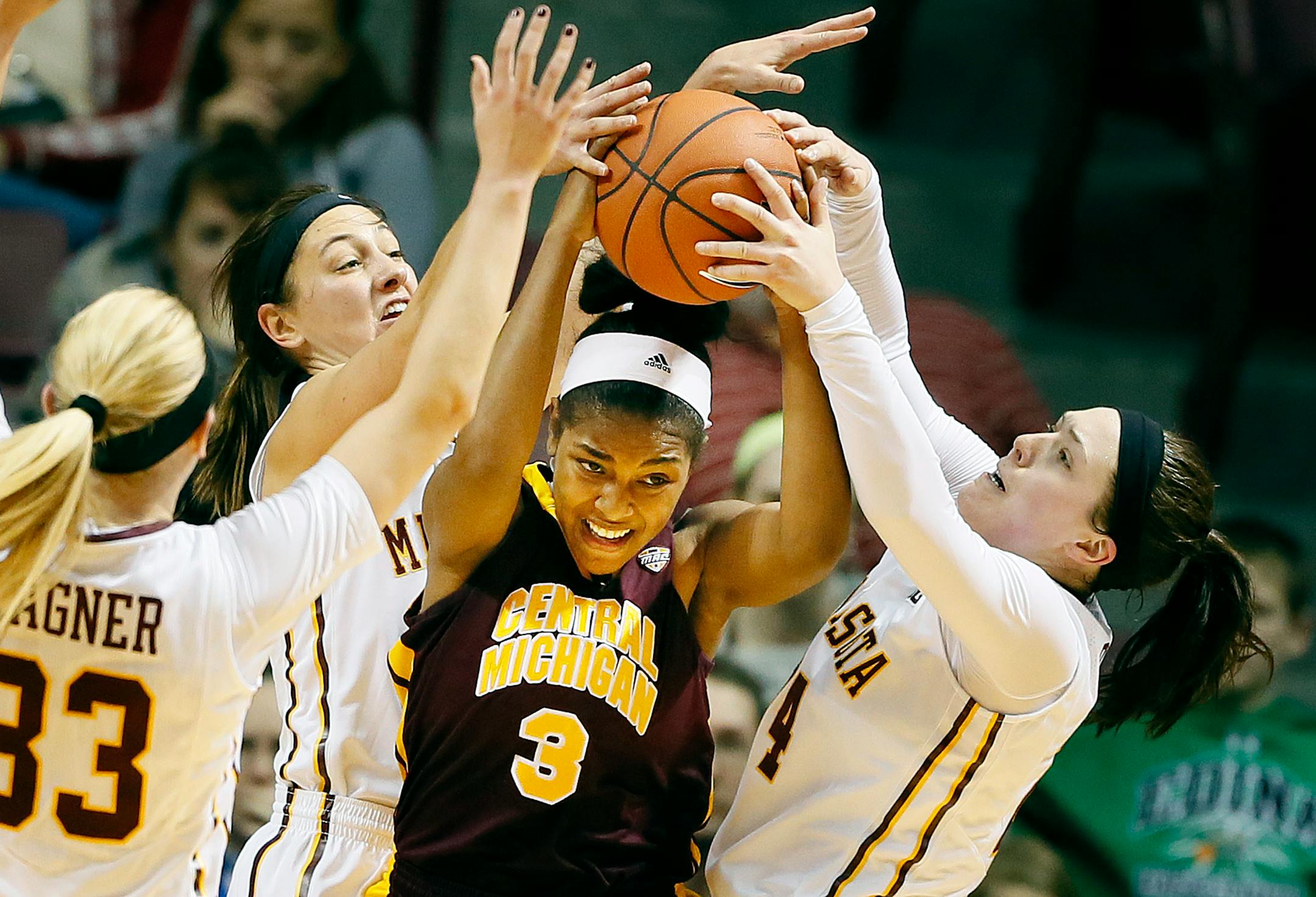 Central Michigan guard Jessica Green (3) was surrounded by Minnesota defenders Carlie Wagner (33), Shayne Mullaney (3), and Mikayla Bailey (24) during the Subway Classic at Williams Arena on Sunday December 21, 2014 in Minneapolis.