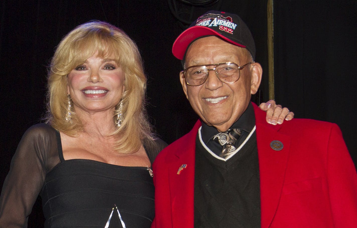 FILE - In this Sept. 11, 2013 file photo, actress Loni Anderson, left, receives the Millie Taylor award from Lt. Col. Bob Friend, a Tuskegee Airman, during the 2nd Annual Heroes Helping Heroes Benefit Concert at The House of Blues, in Los Angeles. World War II pilot Friend, one of the last original members of the famed all-black Tuskegee Airmen, has died at the age of 99. Friend&#x2019;s daughter, Karen Friend Crumlich, told The Desert Sun her father died Friday, June 21, 2019, at a Southern Cal