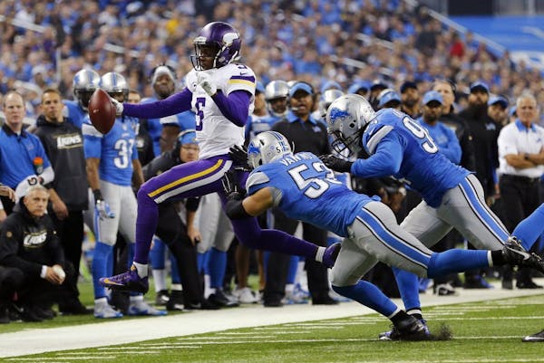Minnesota Vikings quarterback Teddy Bridgewater (5) is pushed out of bounds by Detroit Lions outside linebacker Kyle Van Noy (53) and defensive end Ez