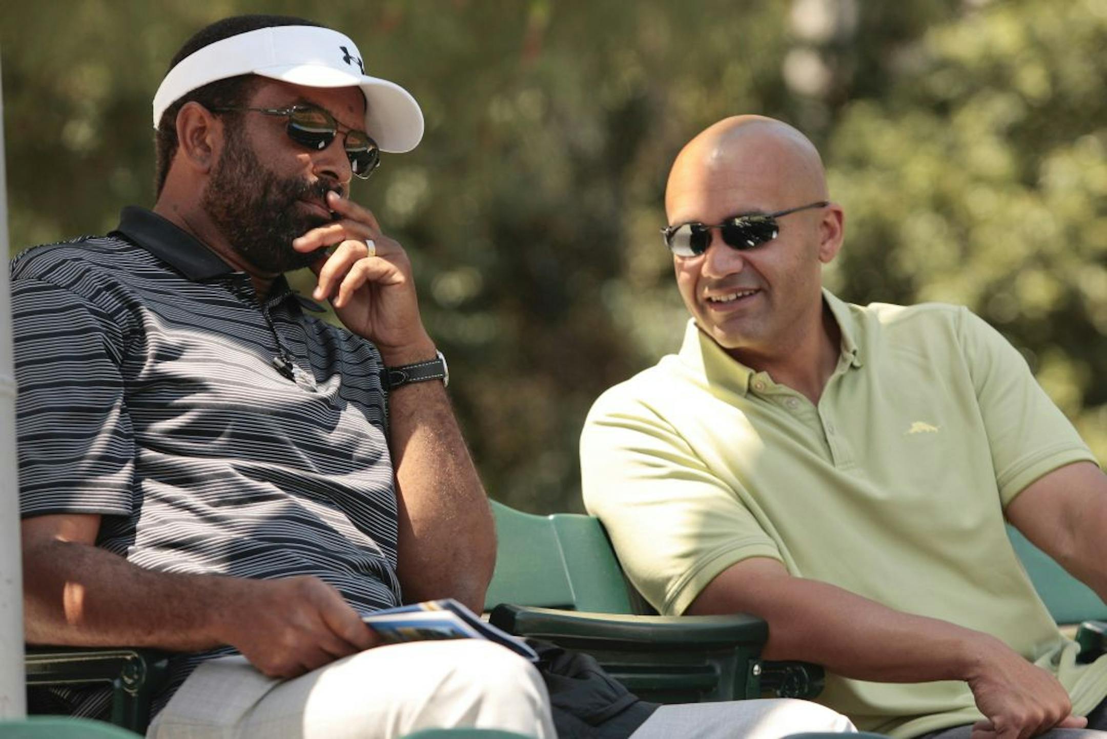 Twins scouting director Deron Johnson, left, and Twins scout Sean Johnson talk before a NCAA baseball game between Stanford and UCLA in Los Angeles, Saturday, April 28, 2012.