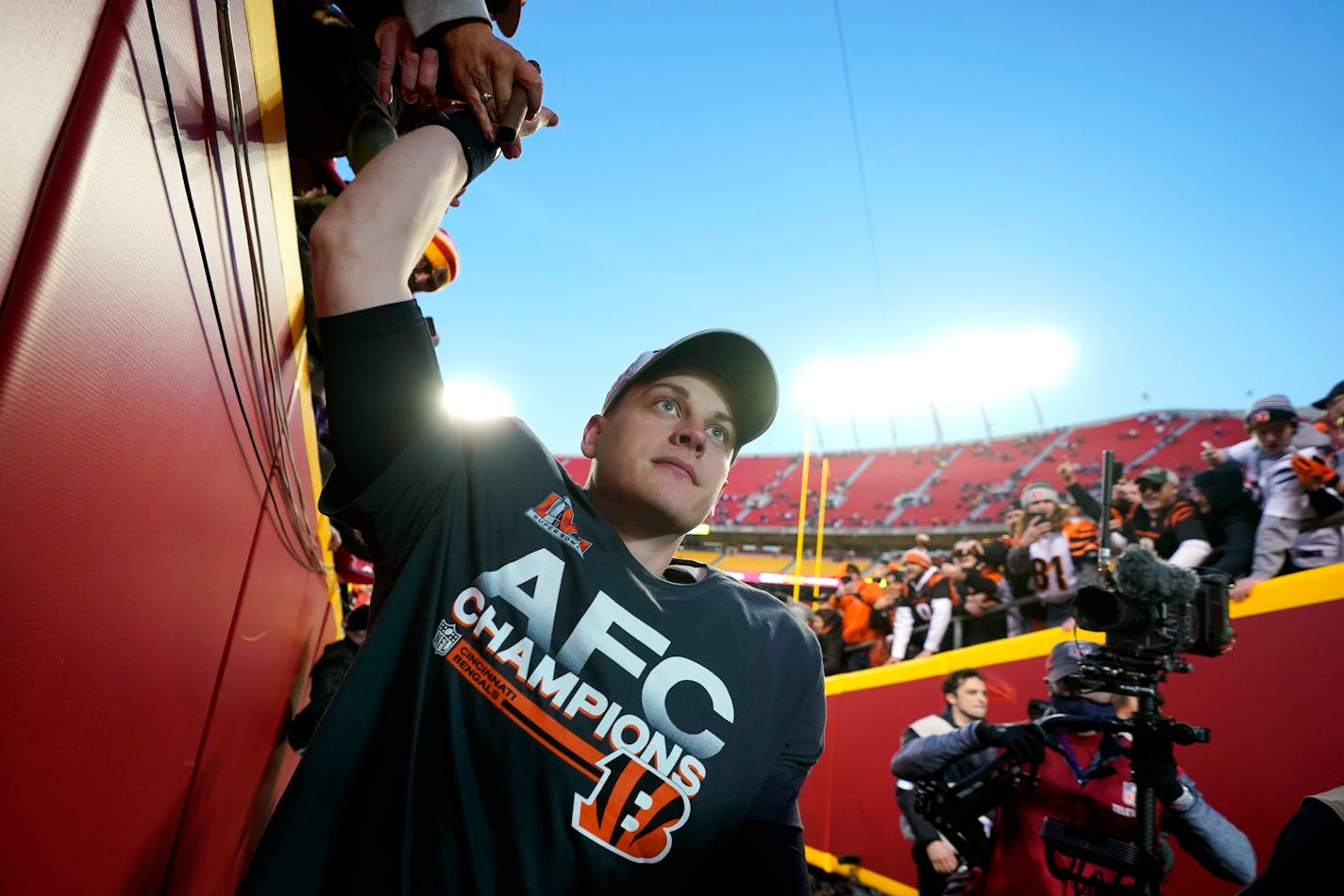 Cincinnati Bengals quarterback Joe Burrow celebrates with fans after the AFC championship NFL football game against the Kansas City Chiefs, Sunday, Jan. 30, 2022, in Kansas City, Mo. The Bengals won 27-24 in overtime. (AP Photo/Paul Sancya)