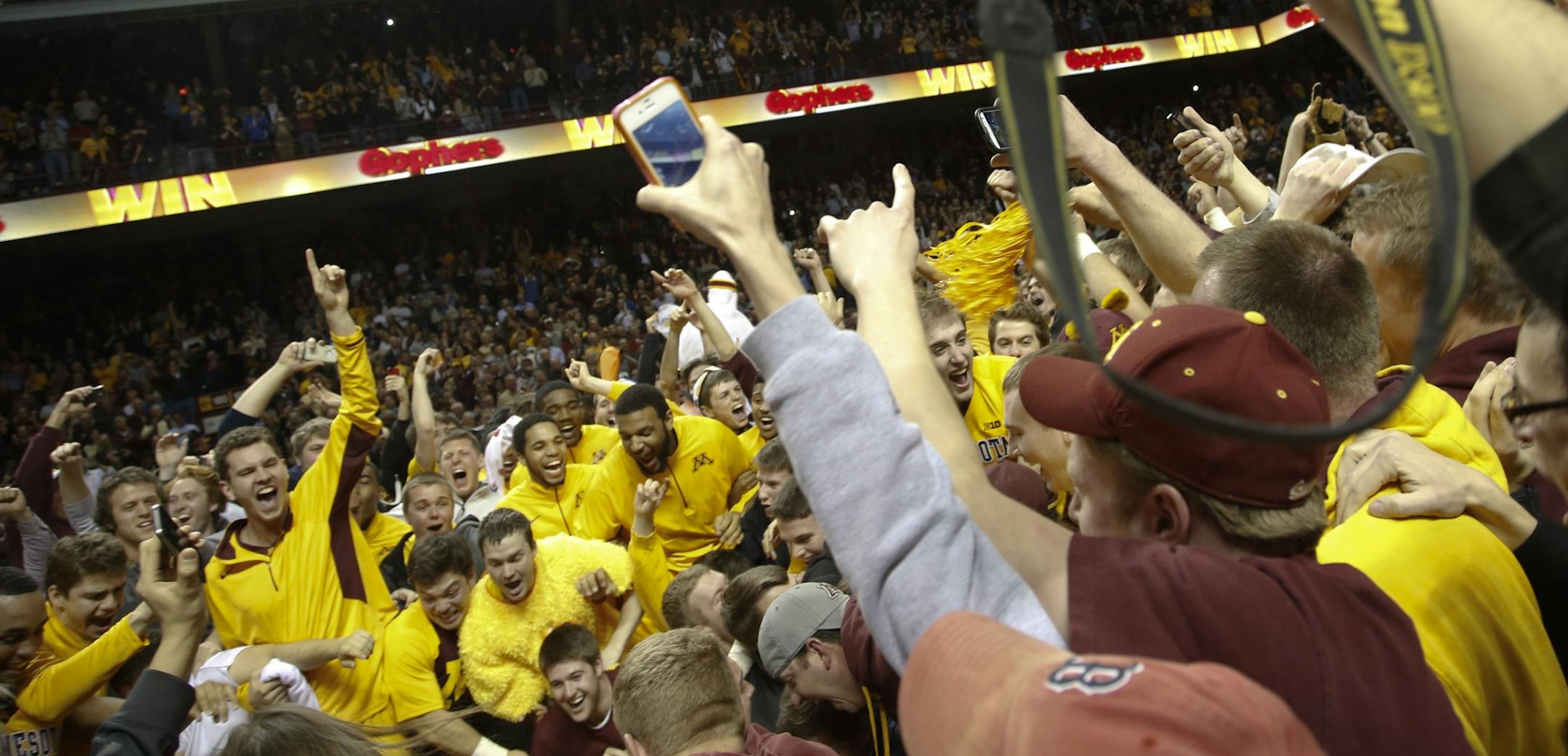 The Gophers, reveling with fans who stormed the court, believe their closed-door session helped in Tuesday's victory.