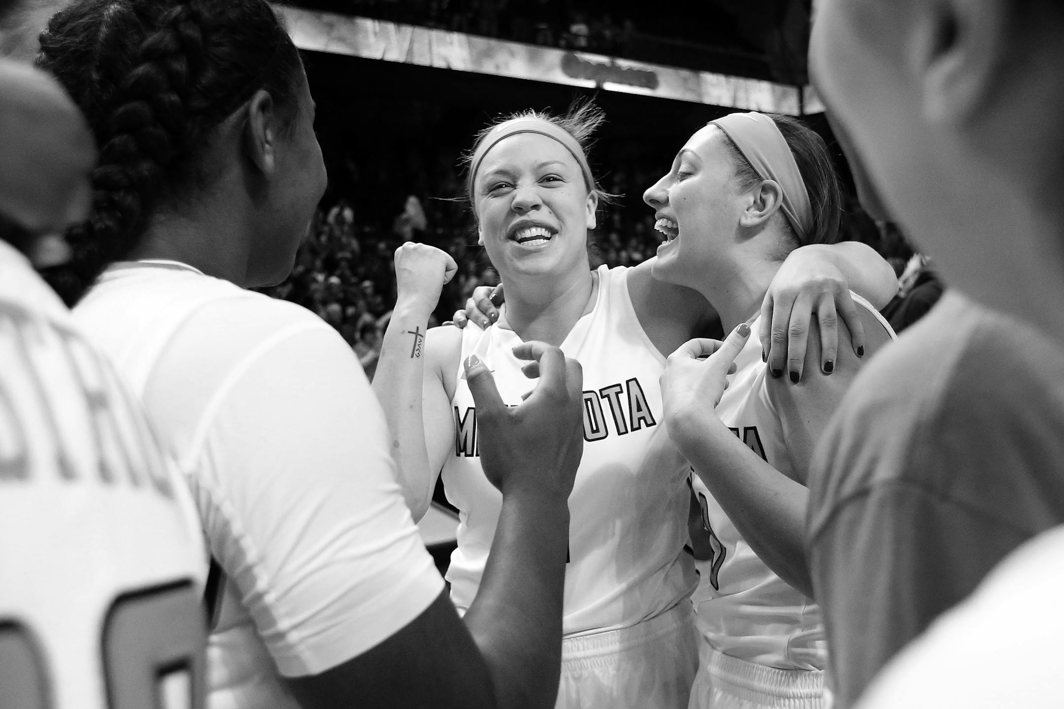 Rachel Banham (1) celebrated with teammates at the end of the game. Banham (1) made a three pointer in the in the final second of the game. Minnesota beat Iowa by a final score of 78-76. Banham finished with 35 points.