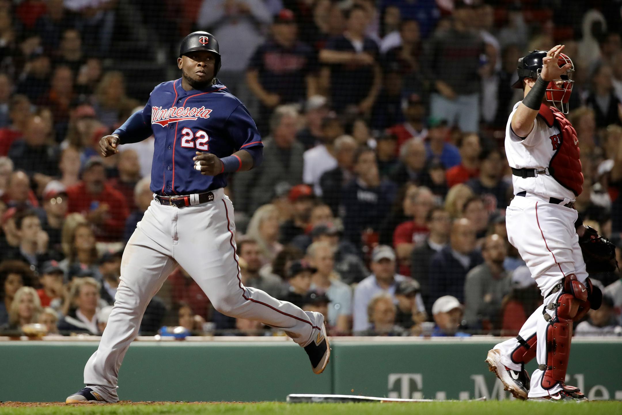 The Twins' Miguel Sano scores on a single by Willians Astudillo as Boston catcher Christian Vazquez stands at right during the seventh inning on Thursday.