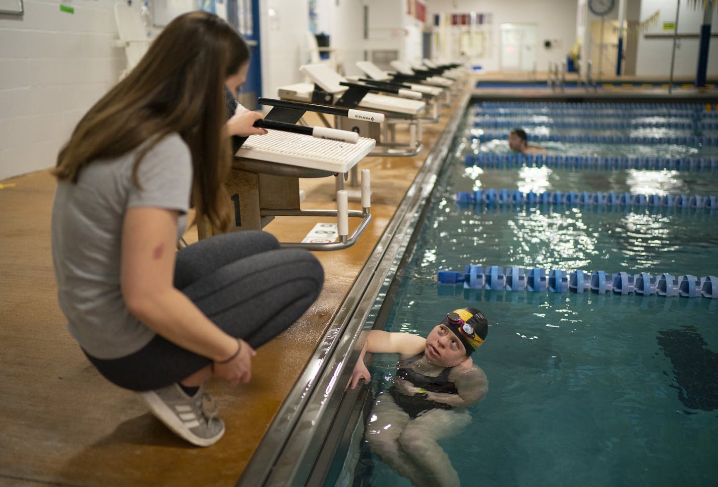 Volunteer Chloe Swanson, an Edina High School swimmer, coached Abby Hirsch, 26, an original Clownfish member and Special Olympics gold medalist. Above,