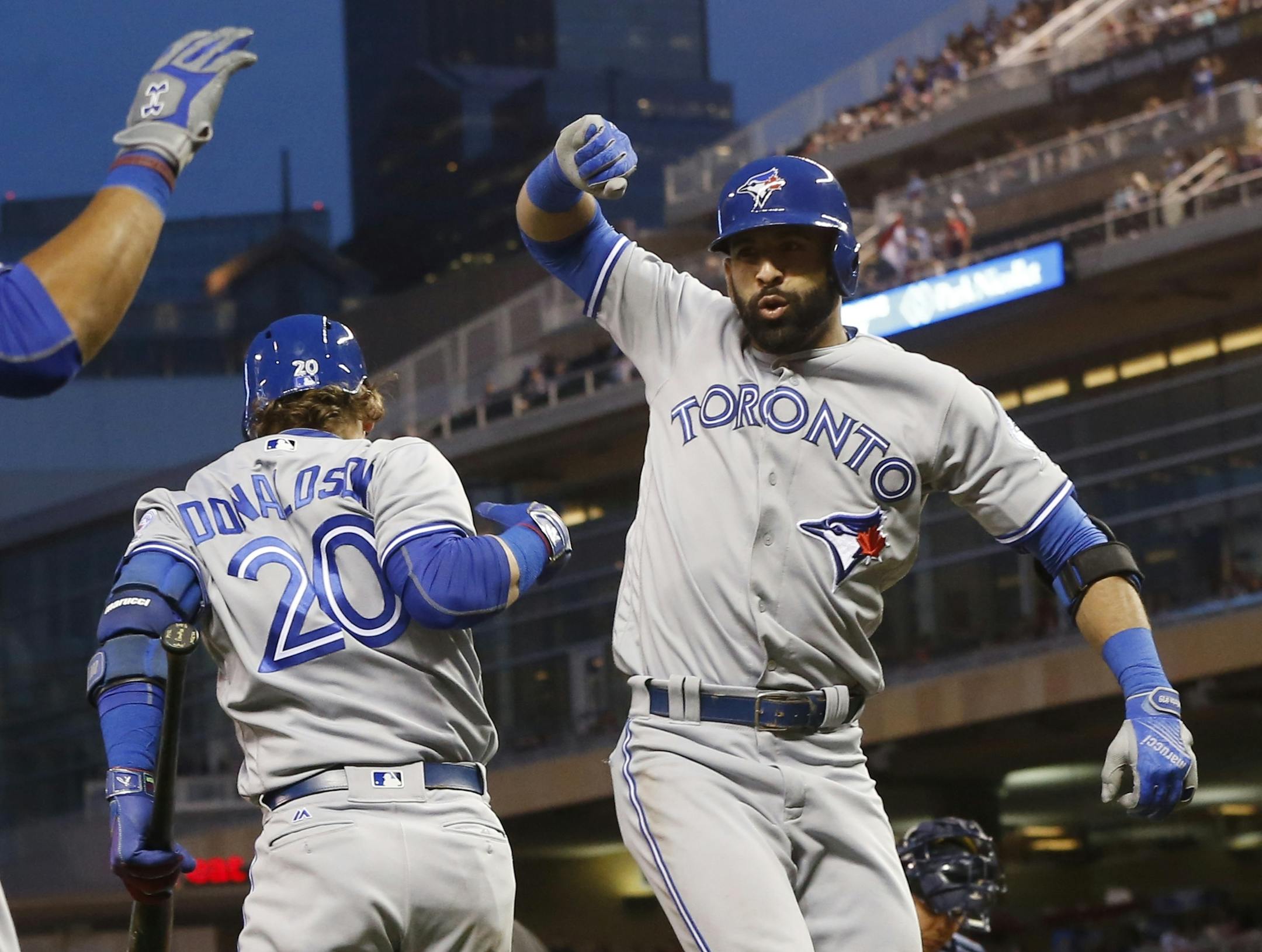 Toronto Blue Jays� Jose Bautista, right, celebrates his three-run home run off Minnesota Twins pitcher Trevor May with Josh Donaldson in the sixth inning of a baseball game Friday, May 20, 2016, in Minneapolis. (AP Photo/Jim Mone)