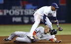 Boston Red Sox's Will Middlebrooks (16) slides under Tampa Bay Rays shortstop Yunel Escobar (11) after he was tagged out on a double play in the third
