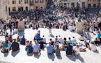Rome, Italy - 3 April 2015: View of tourists gathering around the Spanish Steps. Scenes from Rome, Italy, at Easter time.