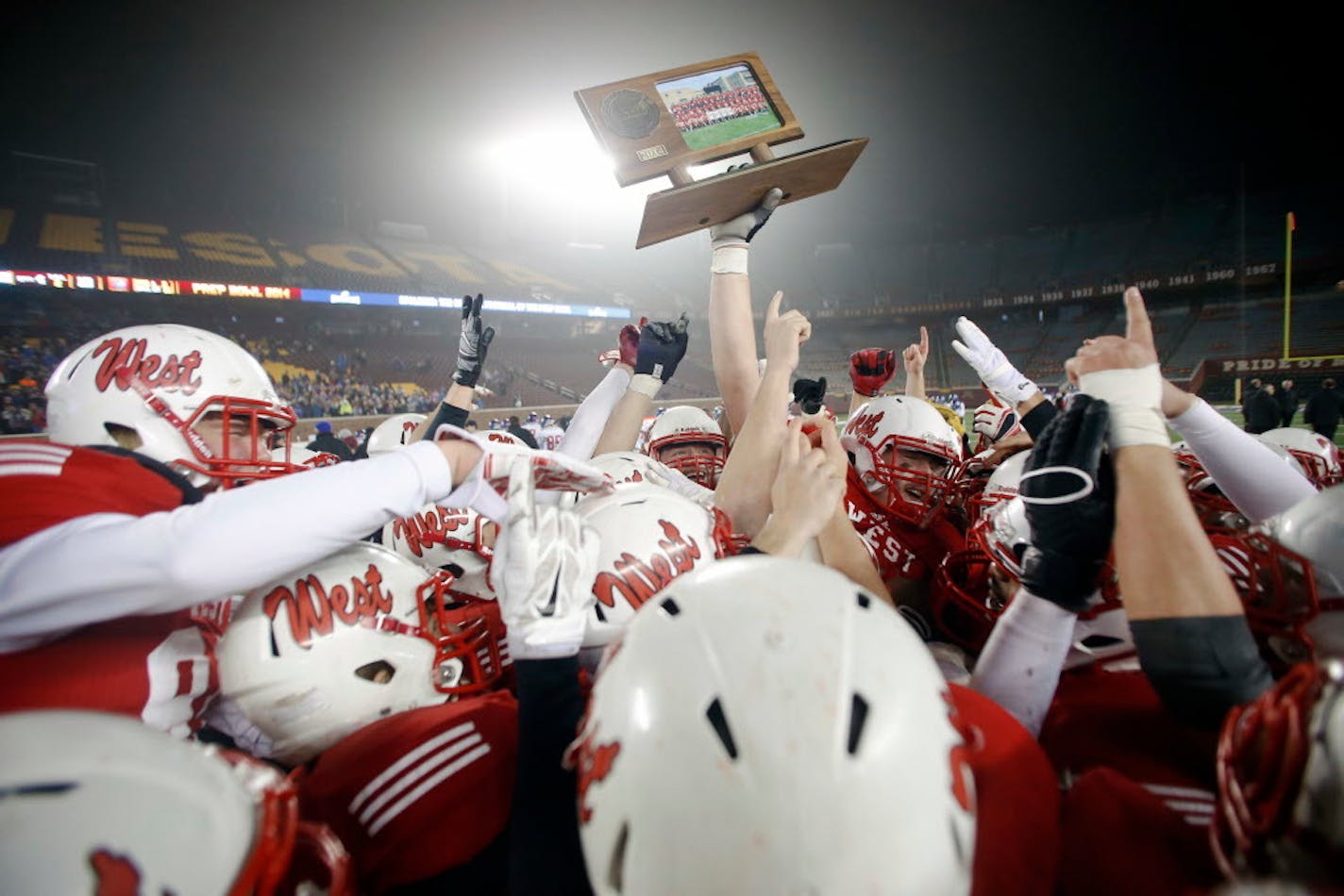 The Mankato West Scarlets celebrate after defeating Simley 42-19 in the Class 5A Prep Bowl Saturday night. ] AARON LAVINSKY � aaron.lavinsky@startribune.com Simley takes on Mankato West in the Class 5A Prep Bowl Saturday, Nov. 22, 2014 at TCF Bank Stadium.