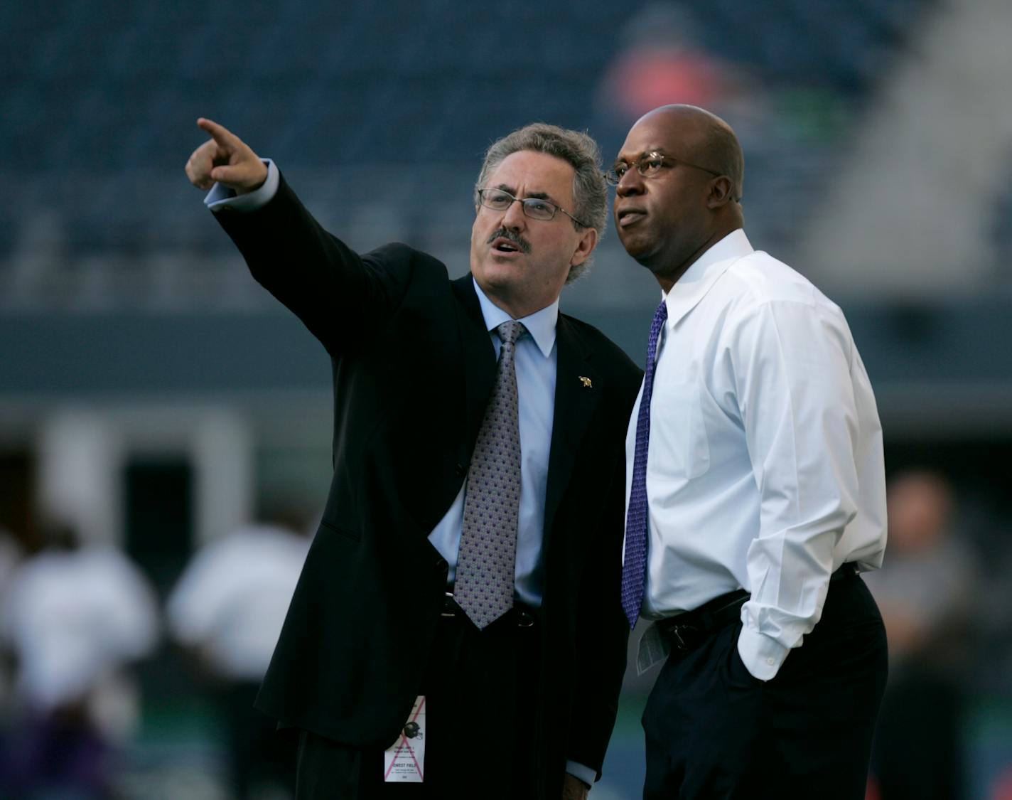 Vikings owner Zygi Wilf, left, and ownership partner Reggie Fowler made note of features of the Seahawks' Qwest Field in 2005. Fowler, who has been plagued by financial woes, no longer has a stake in the Vikings.