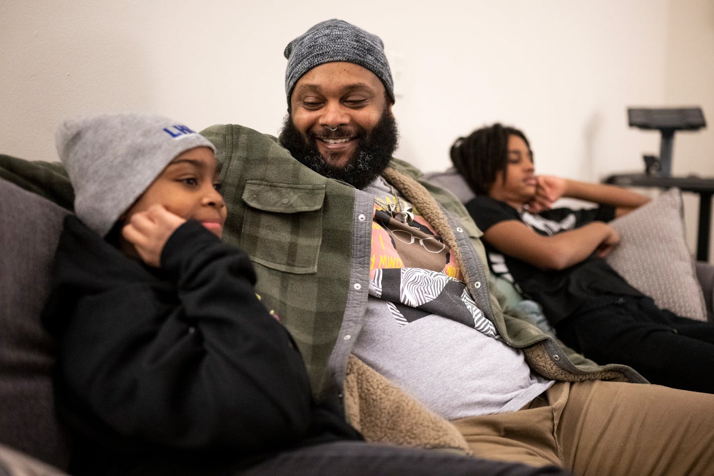 Cameron Taylor sits and watches TV with his 9-year-old daughter Isis and 11-year-old son Nasir Friday, Feb. 10, at Taylor's apartment in Bloomington, Minn. Taylor was charged with and convicted for felony marijuana possession a decade ago. That felony blemish on his record impacted his life ever since, at times preventing him from getting jobs or rental housing he wanted. AARON LAVINSKY • aaron.lavinsky@startribune.com