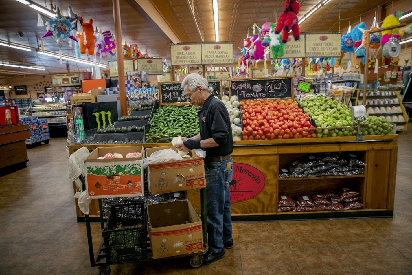 St. Paul's El Burrito Mercado, which includes a grocery, cafeteria, bakery and bar and restaurant, was robbed at gunpoint on Friday. Above, an employee stocked the produce section in March.