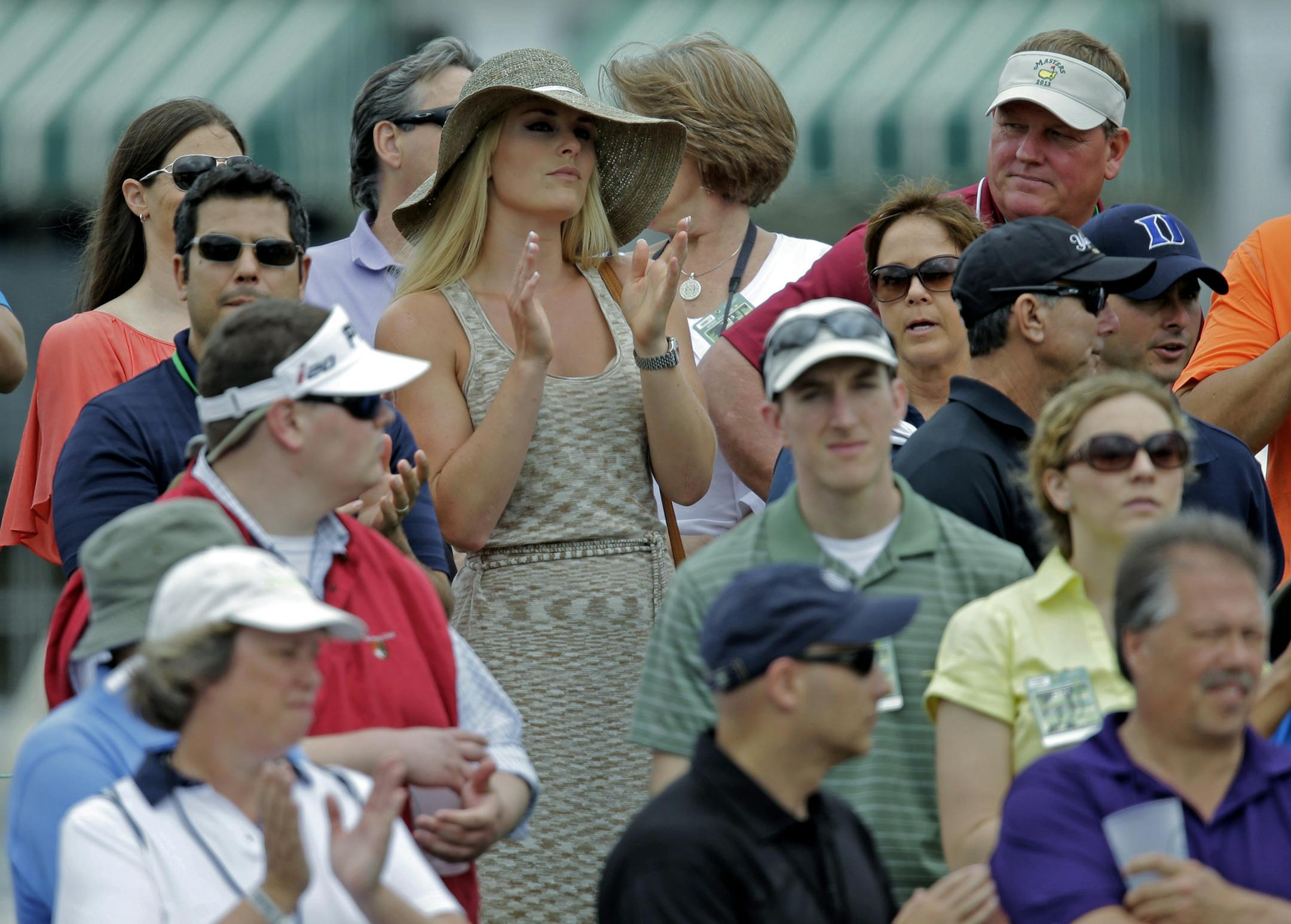 Skier Lindsey Vonn applauds as she watches Tiger Woods during the first round of the Masters golf tournament Thursday, April 11, 2013, in Augusta, Ga. (AP Photo/Matt Slocum)