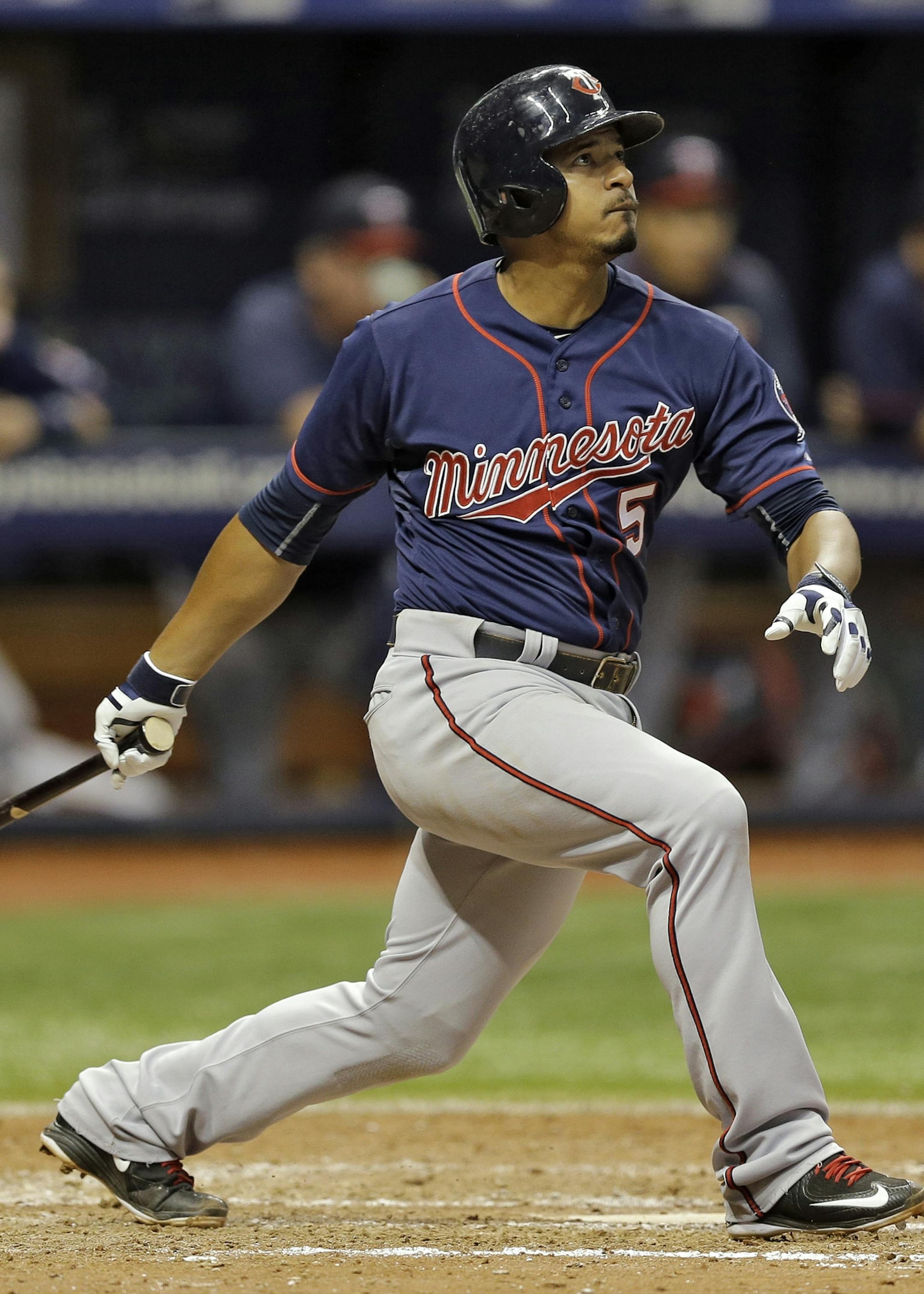 Minnesota Twins' Eduardo Escobar follows the flight of his home run off Tampa Bay Rays relief pitcher Brandon Gomes during the eighth inning of a baseball game Wednesday, Aug. 26, 2015, in St. Petersburg, Fla. Catching for the Rays is Rene Rivera. (AP Photo/Chris O'Meara)