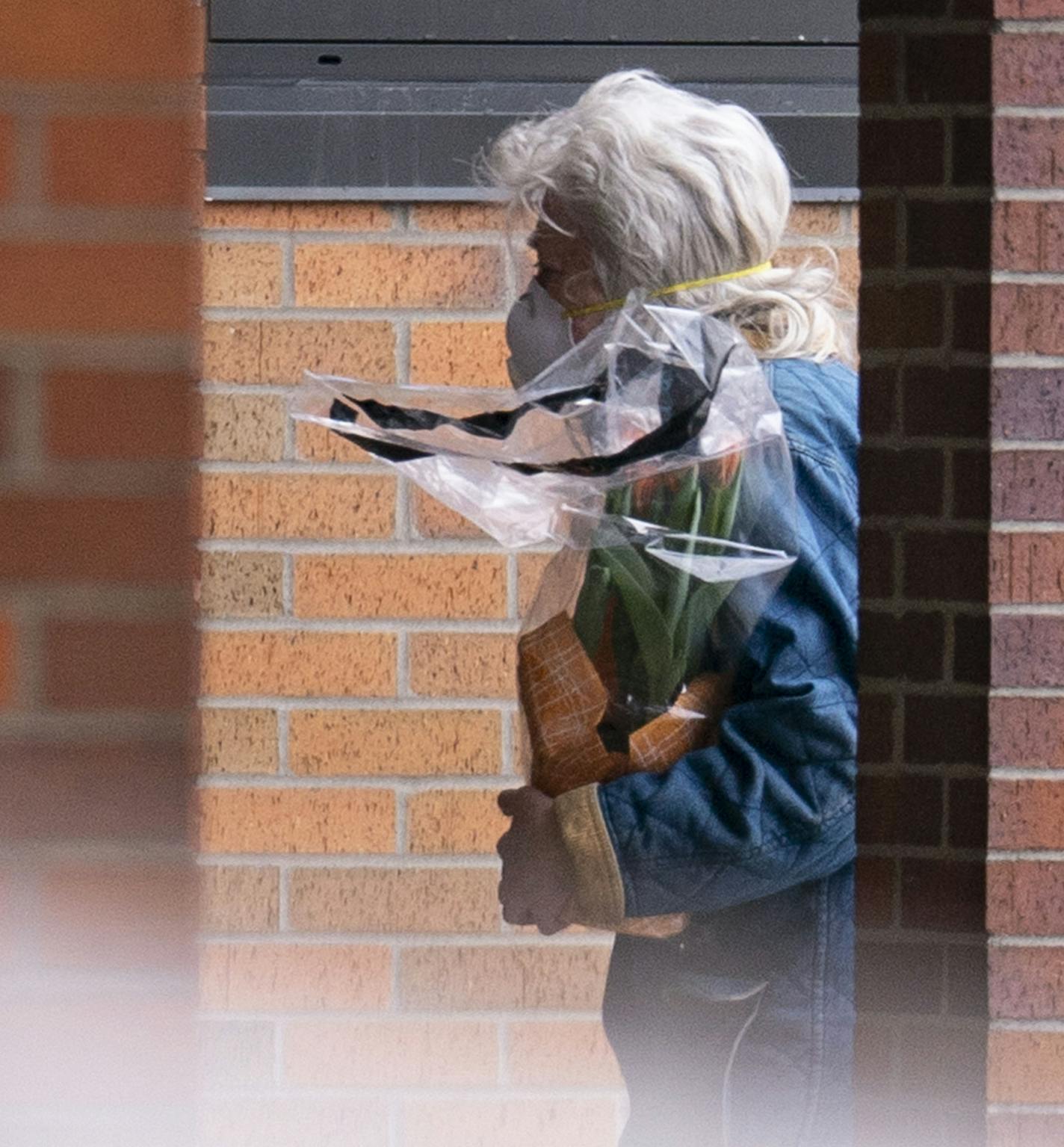 A woman walked towards the front door of St. Ann's Residence in Duluth, MN with flowers in hand on Thursday morning. The residence has reported COVID-19 cases among it's residents on Wednesday April 8, 2020. ]
ALEX KORMANN &#x2022; alex.kormann@startribune.com St. Ann's Residence in Duluth, MN has reported COVID-19 cases among it's residents on Wednesday April 8, 2020.