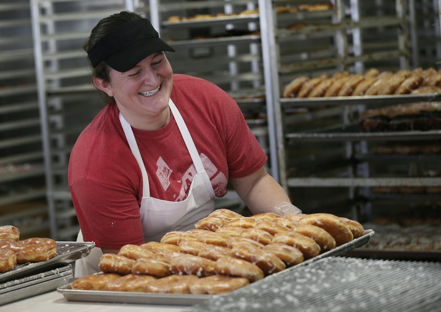 ReNee Hanson carried a tray of fresh donuts Tuesday March 25, 2014 at Hans Bakery in Anoka, Minnesota ]JERRY HOLT jerry.holt@startribune.com