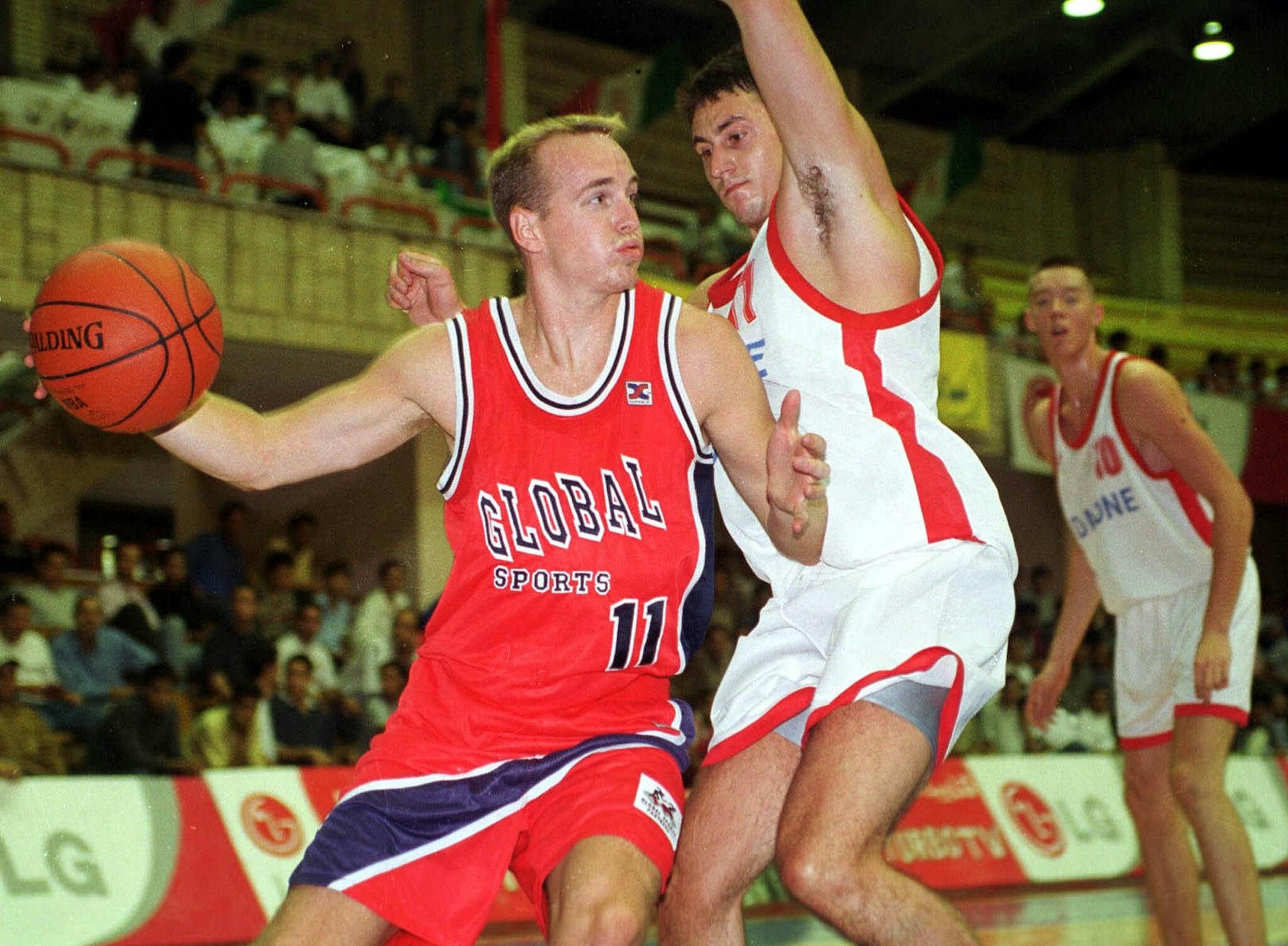 Mike Penberthy, from Los Angeles, Calif., left, of the Global Sports Partners of USA team, tries to get past an unidentified player of the Hungarian team Honved during the second day of the 1st Sport & Nations International Basketball Tournament in the Azadi Complex in Tehran, Monday August 16, 1999. The US team won 71-50. (AP Photo/Kamran Jebreili)