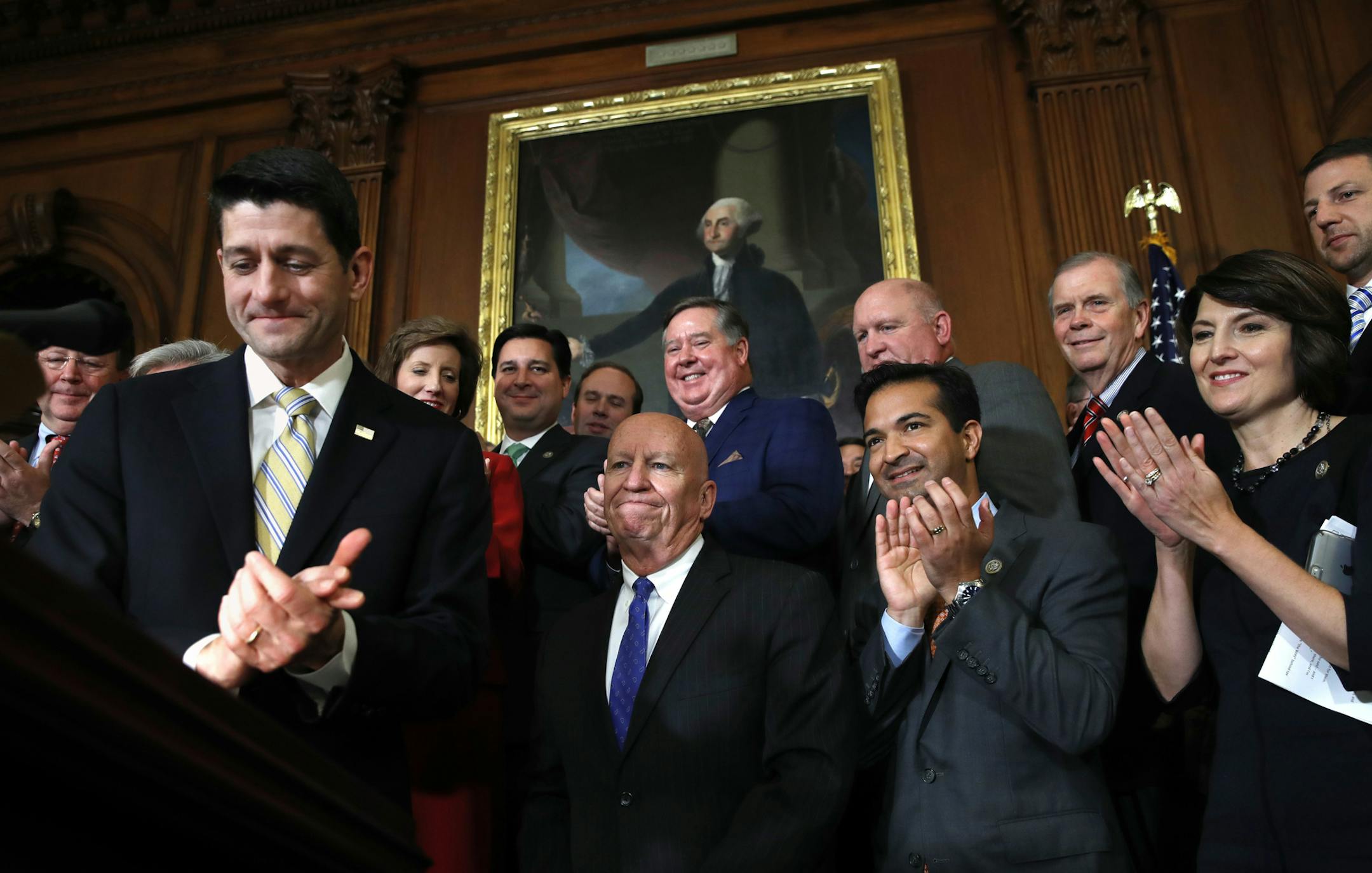House Speaker Paul Ryan of Wis., left, leads applause for House Ways and Means Chair Rep. Kevin Brady, R-Texas, along with Rep. Carlos Curbelo, R-Fla., and Rep. Cathy McMorris Rodgers, R-Wash., during a news conference following a vote on tax reform on Capitol Hill in Washington, Thursday, Nov. 16, 2017. Republicans passed a near $1.5 trillion package overhauling corporate and personal taxes through the House, edging President Donald Trump and the GOP toward their first big legislative triumph i