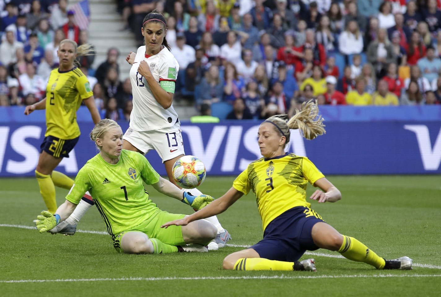 Sweden goalkeeper Hedvig Lindahl and teammate Linda Sembrant attempt to control the ball as United States' Alex Morgan watches during the Women's World Cup Group F soccer match between Sweden and the United States at Stade Oc&#xe9;ane, in Le Havre, France, Thursday, June 20, 2019. (AP Photo/Alessandra Tarantino)