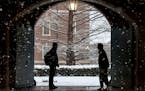 Wheaton College students stop to chat on the Norton, Mass. campus, Feb. 13, 2024 as snow falls. More than 75 million student loan borrowers have enrol
