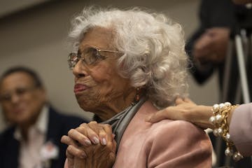 Dr. Josie Robinson Johnson reacted as University President Eric Kaler read the description of her that will be posted in the community room that was b