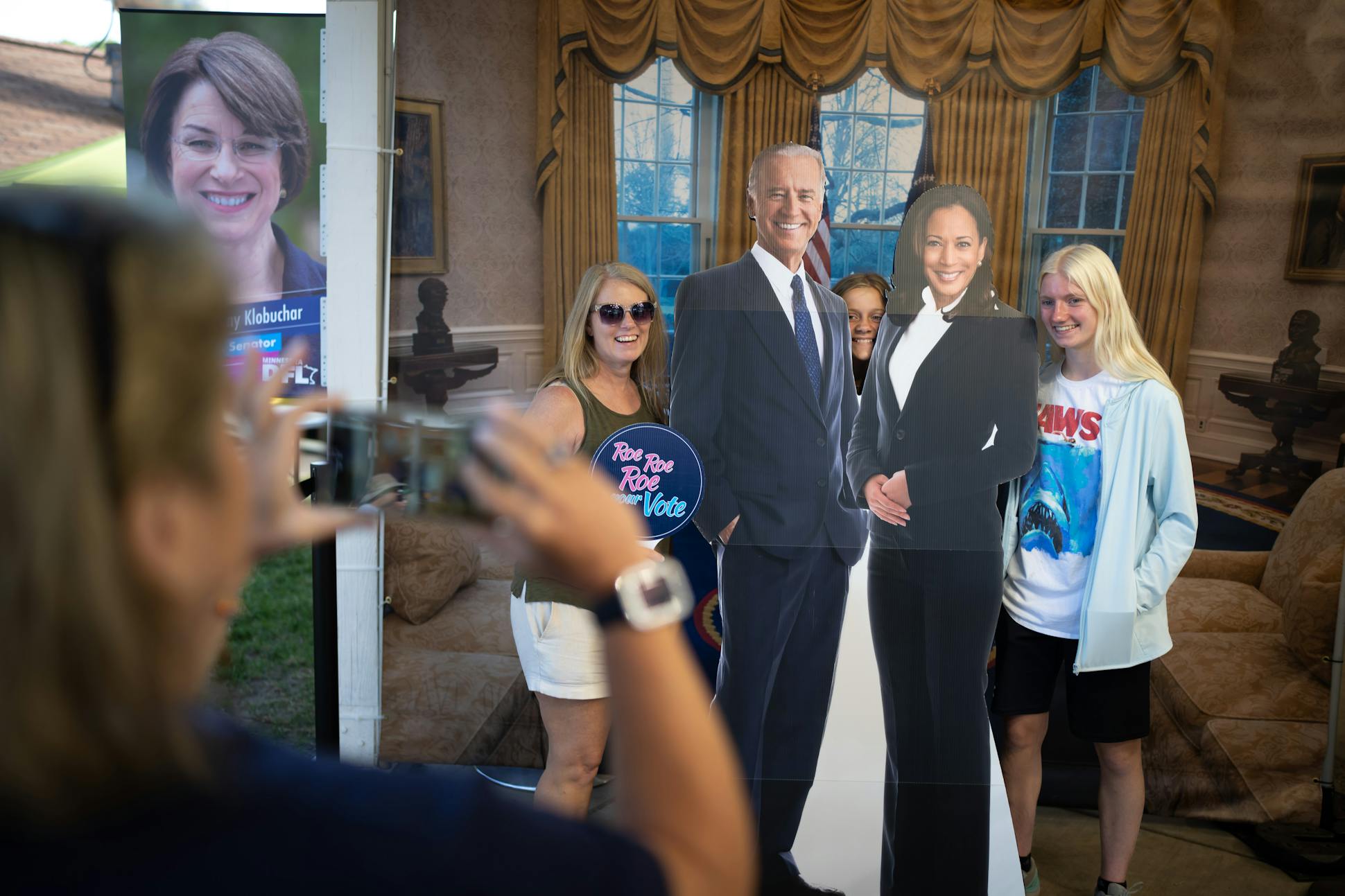 Volunteer Carol Grabowski took a photo of Pam Vandersluis of Buffalo, Minn., along with her two daughters Jordan, 12, and Lily, 15, at a Biden-Harris display at the DFL booth at the State Fair on Aug. 26.