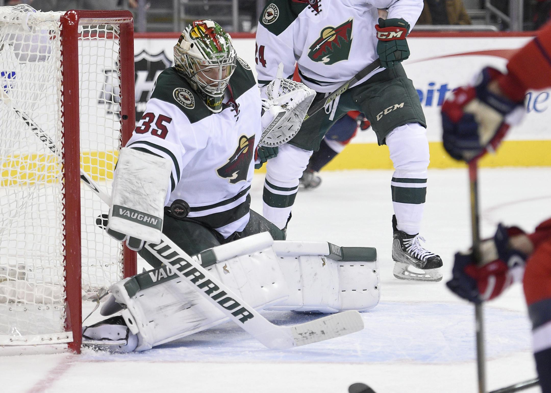 Minnesota Wild goalie Darcy Kuemper (35) stops the puck during the second period of an NHL hockey game against the Washington Capitals, Friday, Feb. 26, 2016, in Washington. (AP Photo/Nick Wass)