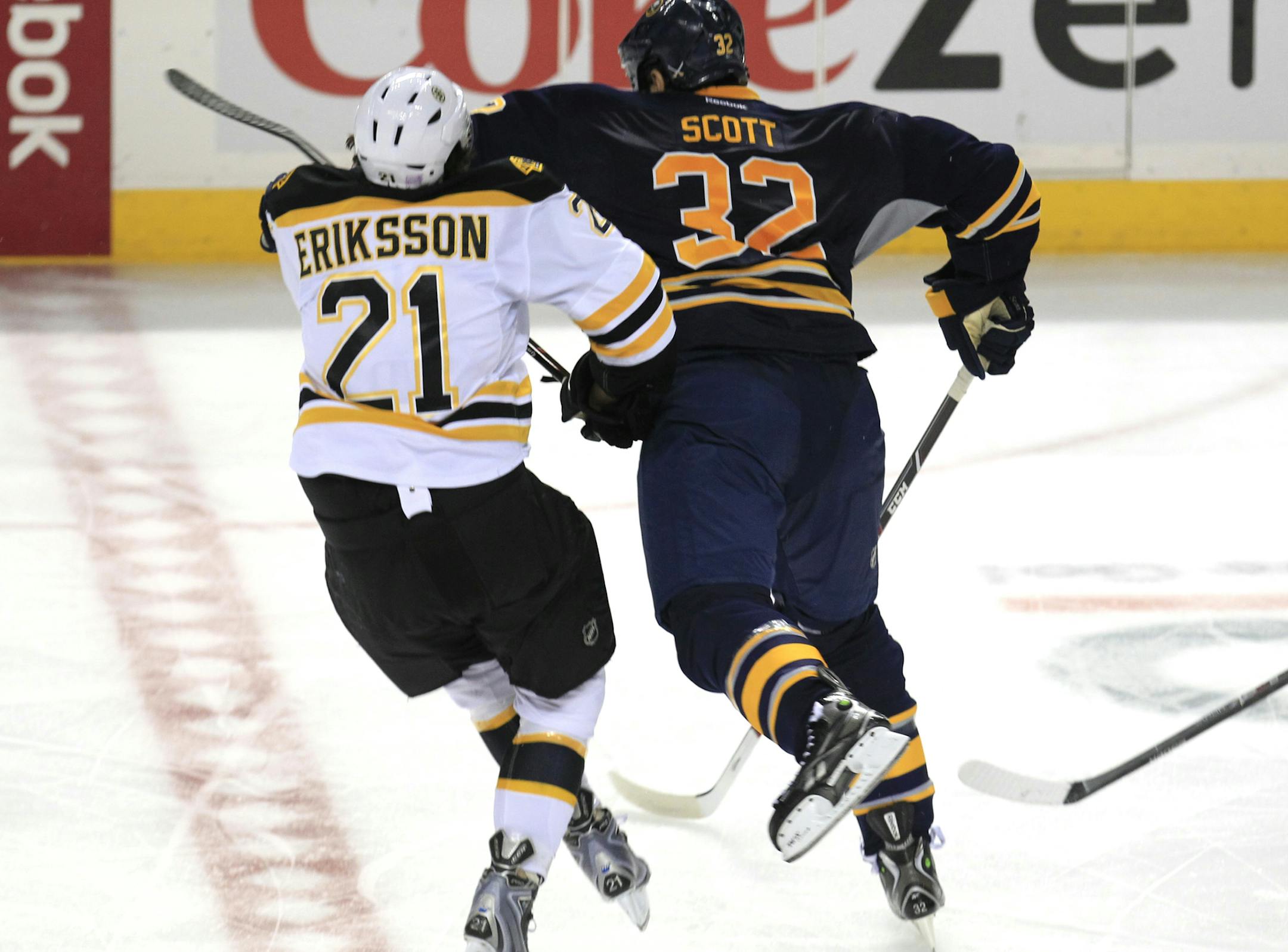 Buffalo Sabre, John Scott (32) checks Boston Bruin, Loui Eriksson (21) during third period action against at the First Niagara Center on Wednesday, Oct. 23, 2013. Scott was ejected from the game in the third period and he received two five-minute major penalties, one for charging and another for fighting. The Boston bruins defeated the Sabres 5-2. (AP/Photo,Harry Scull Jr./Buffalo News)