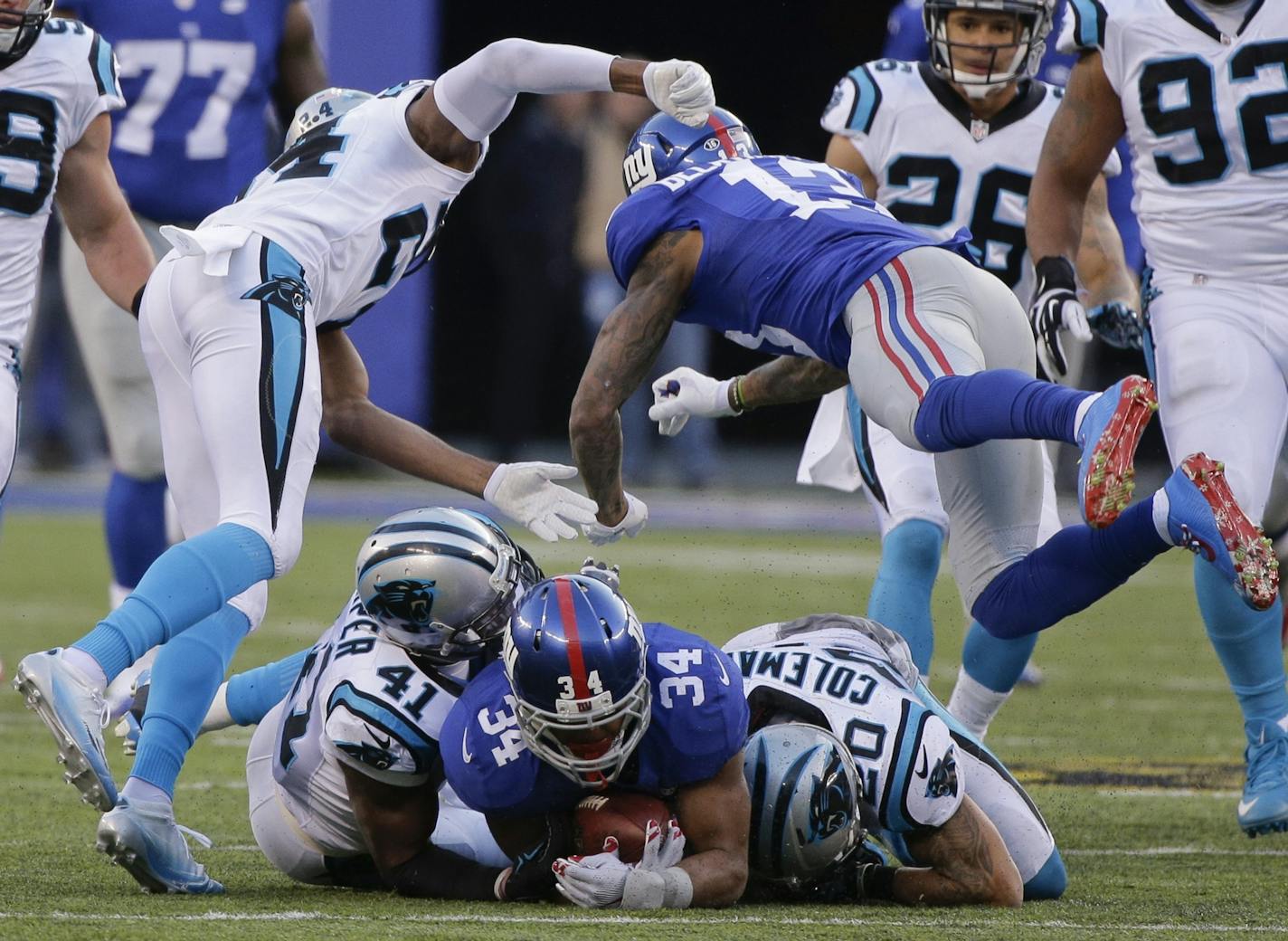 New York Giants' Odell Beckham (13) hits Carolina Panthers' Josh Norman (24) after teammate Shane Vereen (34) is tackled by Kurt Coleman (20) and Roman Harper (41) during the second half of an NFL football game Sunday, Dec. 20, 2015, in East Rutherford, N.J.