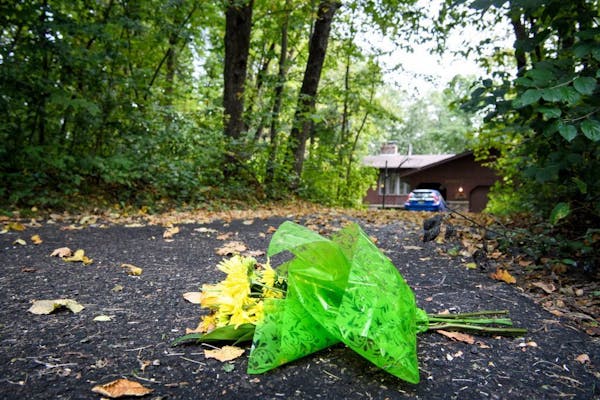 Flowers were left at the foot of the driveway at the home of Patty and Jerry Wetterling in St. Joseph, Minn., Saturday morning.