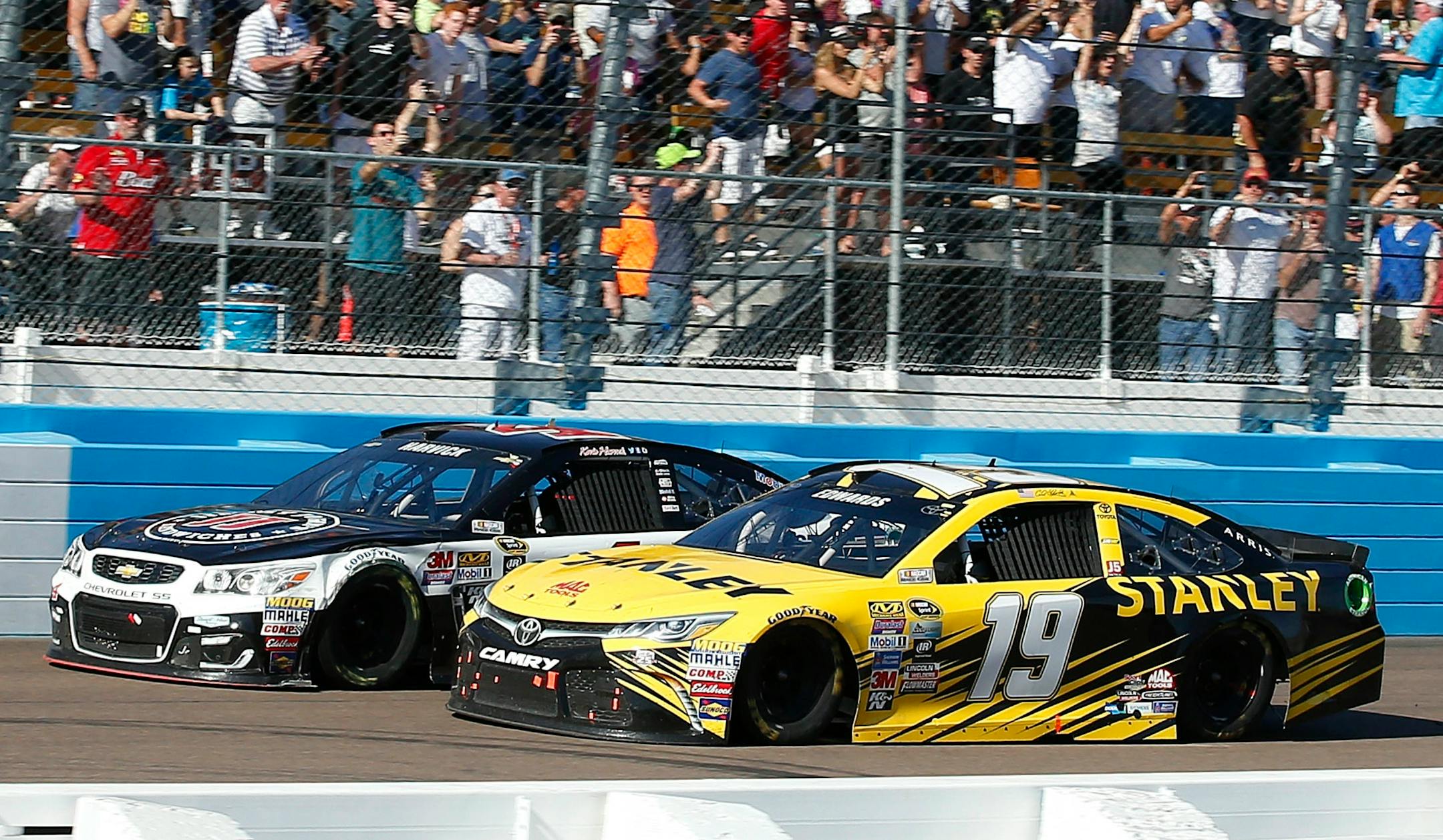 Carl Edwards, right, collided with Kevin Harvick at the finish line during a NASCAR Sprint Cup Series race at Phoenix International Raceway on Sunday. Harvick narrowly defeated Edwards at the finish.