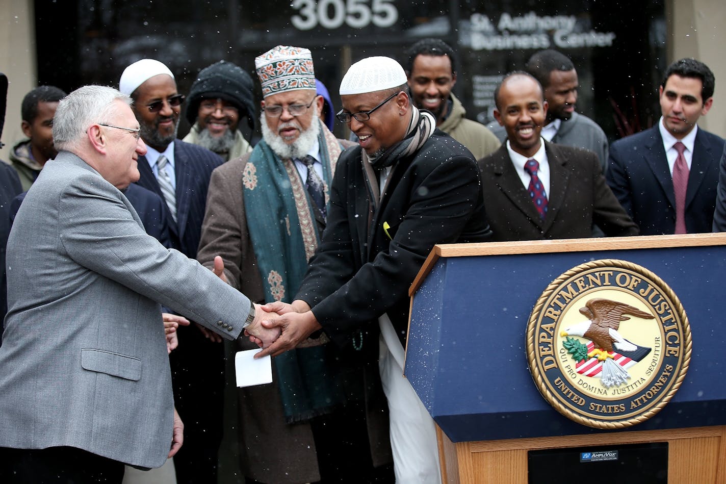 St. Anthony Village Mayor Jerry Faust was greeted by members of the Abu-Huraira Islamic Center after the U.S. Attorney for the District of Minnesota Andrew Luger announced the settlement agreement resolving allegations that the city violated the Religious Land Use and Institutionalized Persons Act of 2000, Tuesday, December 16, 2014 in St. Anthony Village.