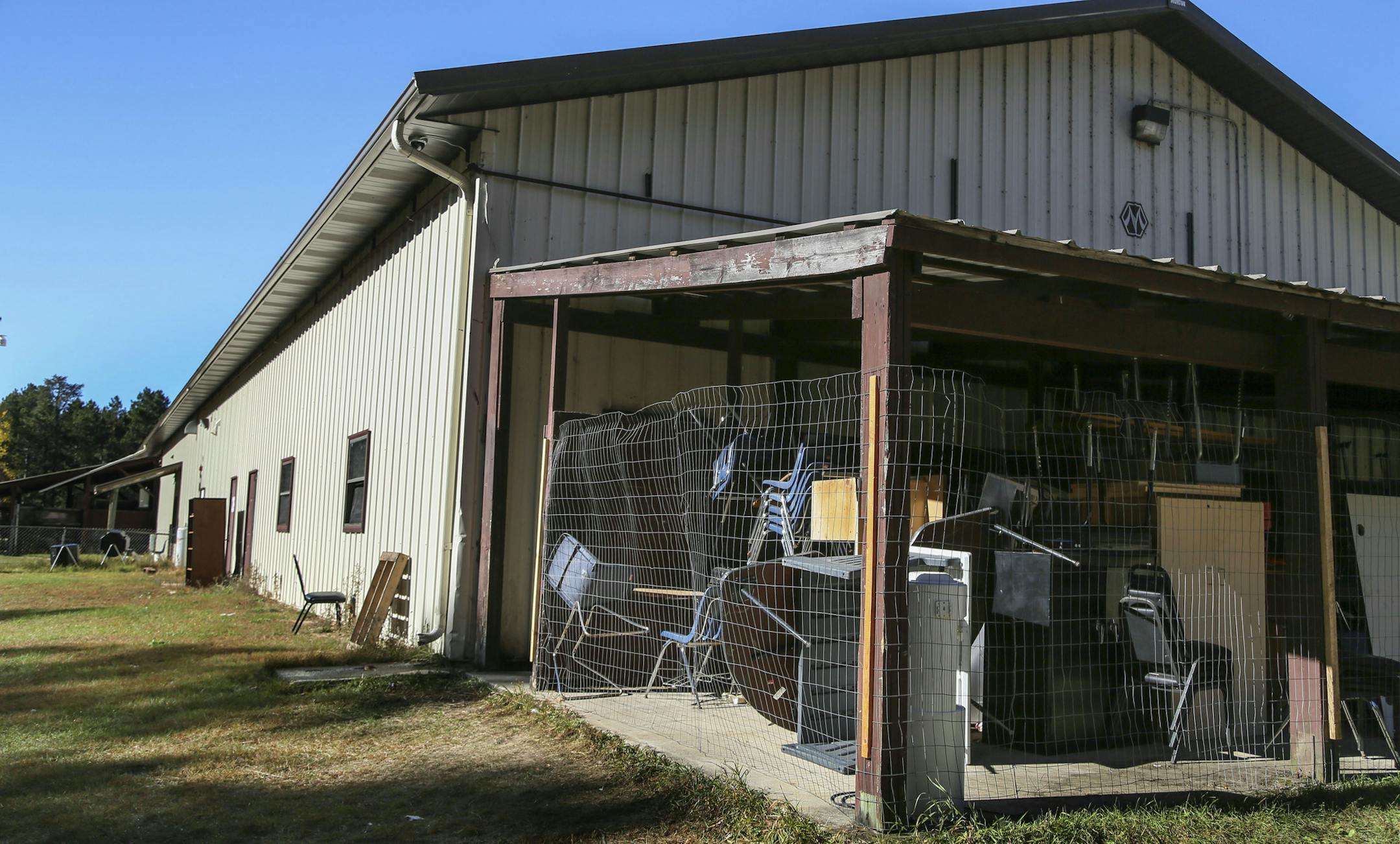 Bug-O-Nay-Ge-Shig High School was once a pole shed for vehicle maintenance and turned into a high school and is lacking much, including storage space. These chairs and desks were seen in an exterior storage space Tuesday, Oct. 21, 2014, in Bena, MN.](DAVID JOLES/STARTRIBUNE)djoles@startribune The Bug O Nay Ge Shig School is a culturally based alternative school that opened in 1975 with a mission of serving Ojibwe children and has matured into a fully accredited educational program. Bug School is