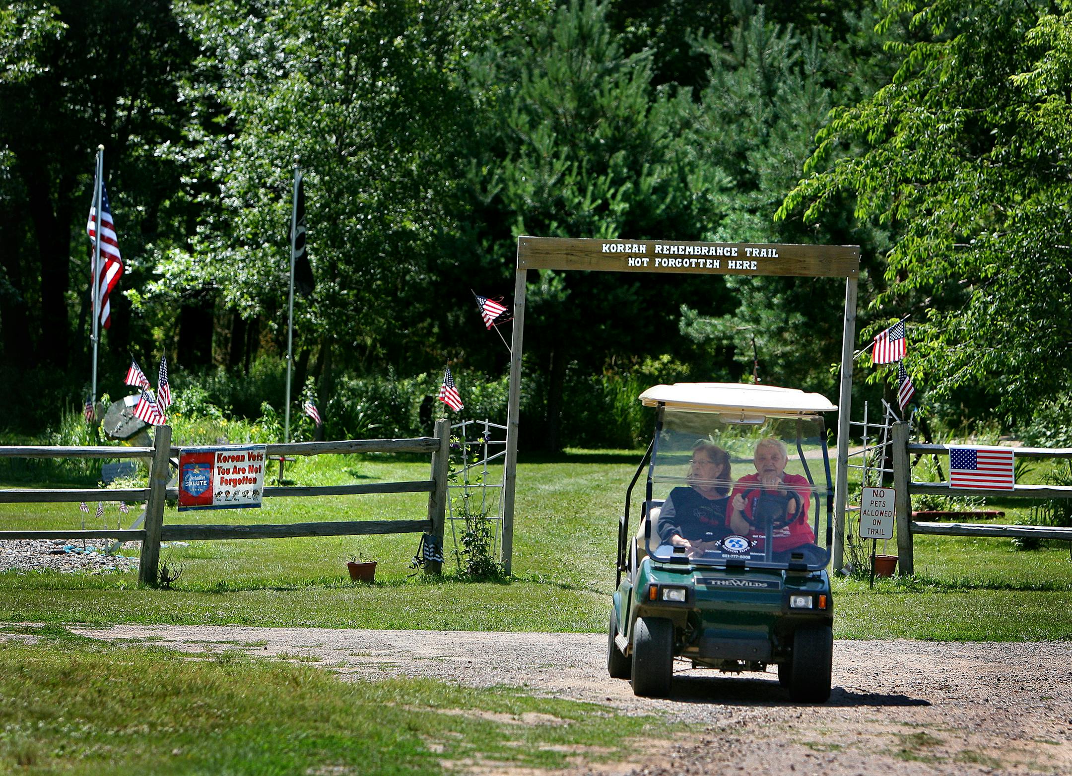 The widows of two World War II veterans made their way from the Korean Remembrance Trail in a golf cart at the Disabled Veterans Rest Camp. The camp, about 75 acres, dates back to 1926 and was a former veteran's hospital. The park has recently been expanded with new RV sites, trails and more.