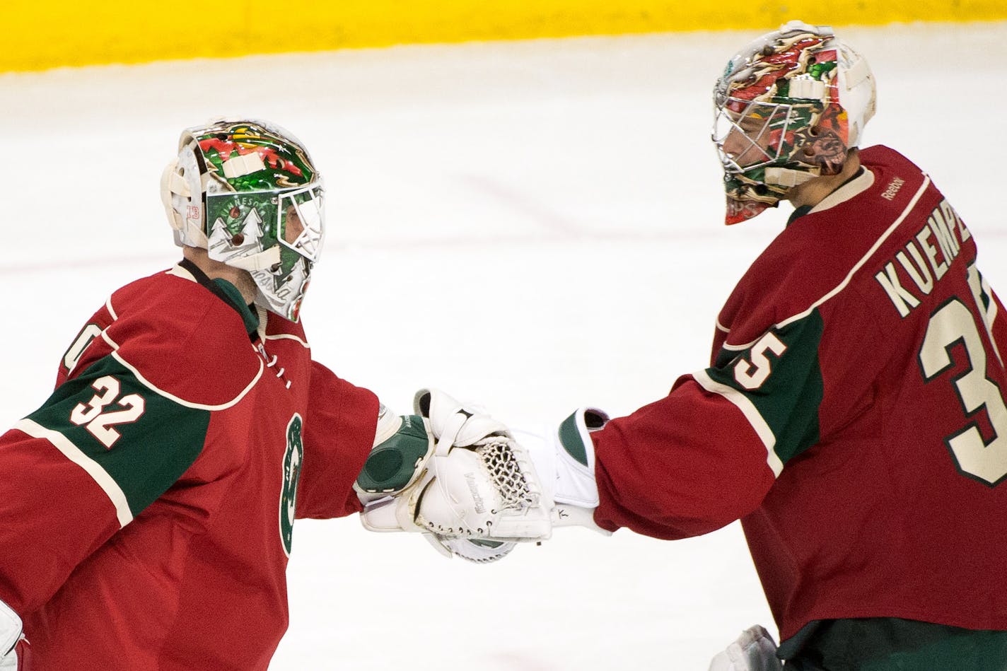 Wild goalies Darcy Kuemper, right, and Niklas Backstrom